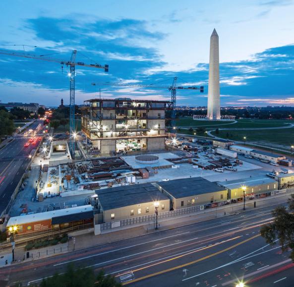 The Smithsonian National Museum of African American History and Culture under construction and the Washington Monument at dusk