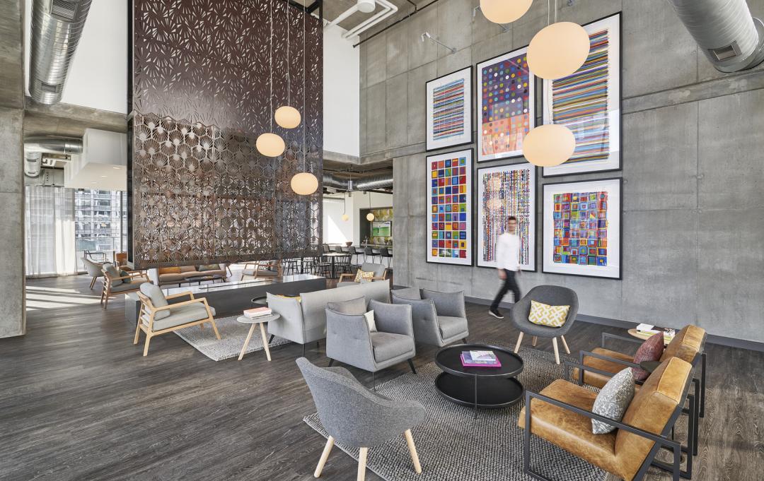 The interior of the residential building Parkline in Chicago with couches, chairs, and overhead lighting